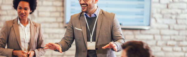 Speaker giving a talk in conference hall at business event.